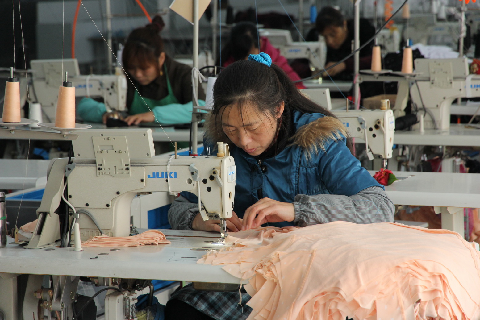 Garment worker sewing apparel at Eleven Garments in Ningbo